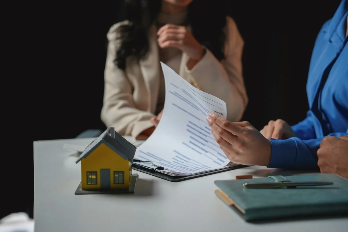 Business compliance and corporate accounting professionals reviewing statutory documentation